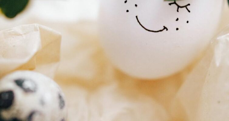 painted smiley face on white egg